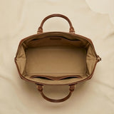 The Voyager full-grain leather weekender duffle — lifestyle travel shot