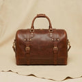 The Voyager full-grain leather weekender duffle bag — front view, Elatheria