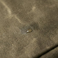 Troubadour gig bag corner detail showing leather trim stitching on waxed canvas