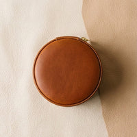 Elatheria Heirloom cylindrical tan leather travel jewelry case brass zipper ring roll