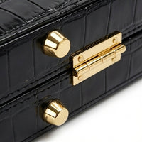 Maestro hard case corner detail showing alligator-embossed leather texture and gold corner protector