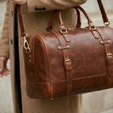 The Voyager full-grain leather heritage weekender duffle — flat lay overhead view