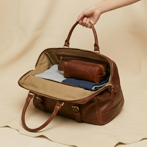 The Voyager heritage leather duffle bag — lifestyle shot, placed on wooden floor