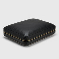 The Haven custom leather orthopaedic pet bed in black full-grain leather, hero angle view