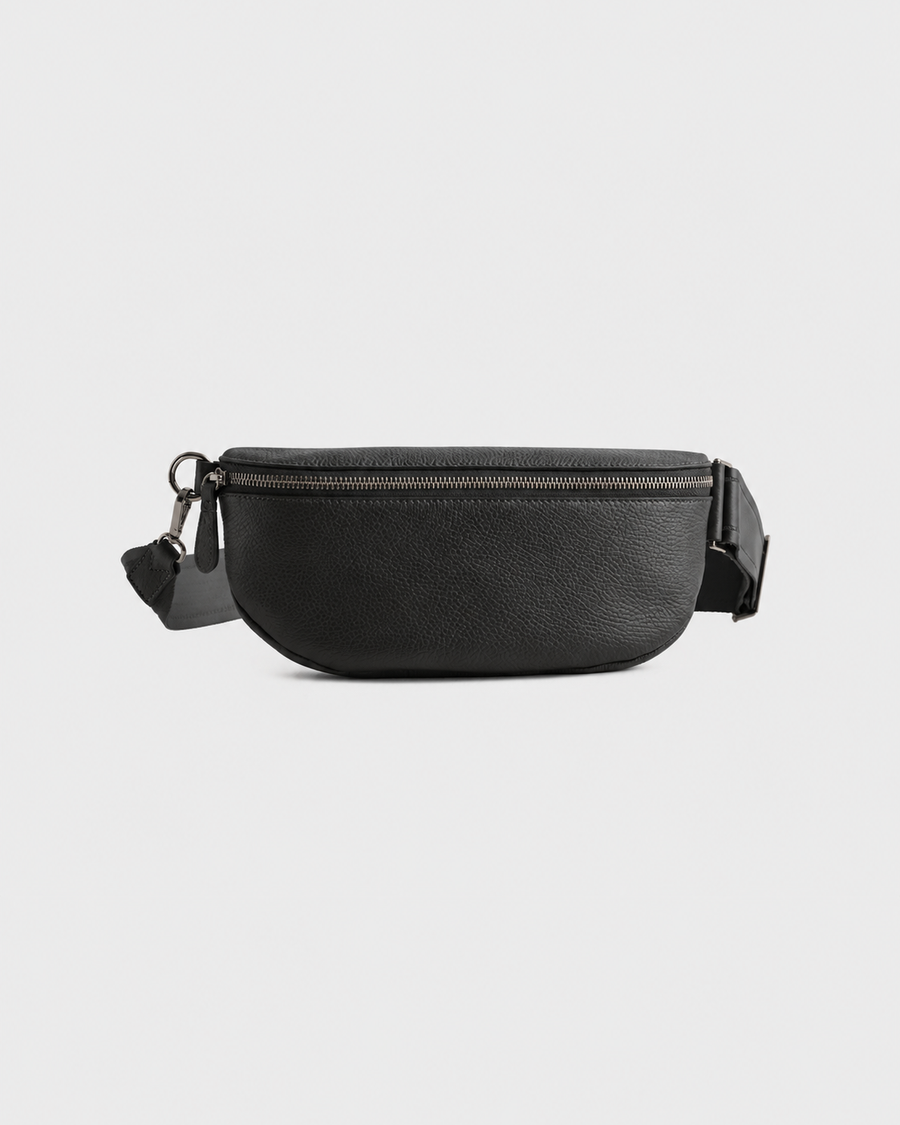 Black Elatheria leather sling bag with gunmetal-tone zipper, front view.