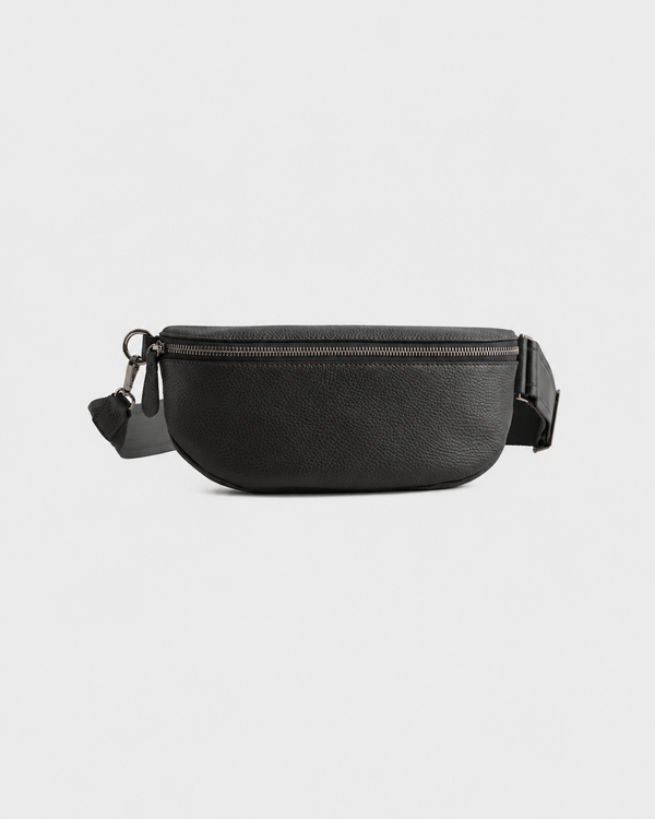 Black Elatheria leather sling bag with gunmetal-tone zipper, front view.