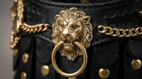 Gold lion-head emblem sculpted detail on The Regal buffalo leather dog collar