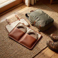 The Voyager leather travel feeding case unrolled flat showing two collapsible silicone bowls