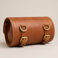 The Voyager leather travel feeding case rolled closed, side profile showing brass D-rings and buckles