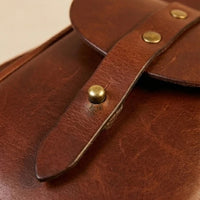 Troubadour Chestnut leather guitar bag lifestyle carry shot, thoughtful gift for him or gift for her