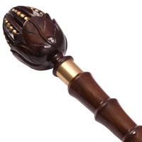 Close-up of The Lotus carved lotus-bud knob handle with gold-tone beads and brass ring collar