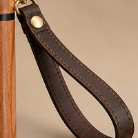 Leather wrist strap with contrast stitching and brass clip on The Regent walking cane