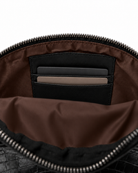 Interior card pockets and dark chocolate fabric lining inside the leather belt bag
