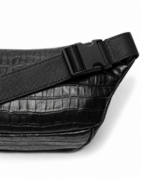 Close-up of the adjustable leather strap and large black plastic buckle