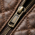 Aviator distressed leather guitar bag lifestyle shot, musician carrying gig bag through city street